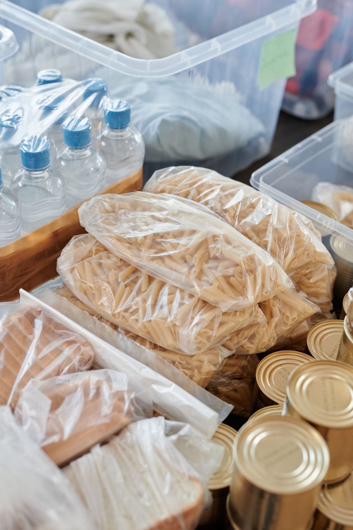 Crates of bagged staples, canned food and bottled water packed together, ready to be handed out.