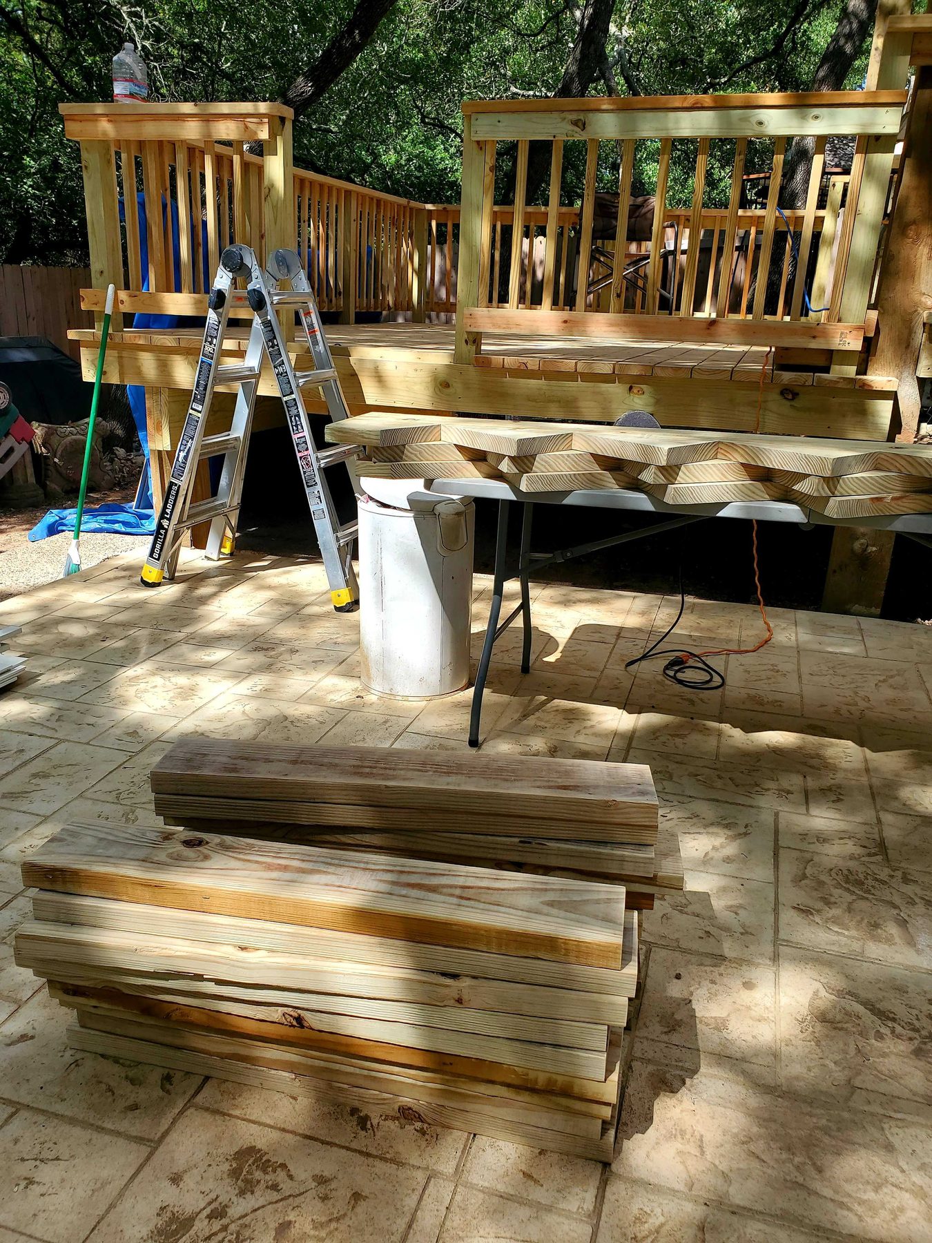 A raised timber deck under construction, joists laid across posts with boards going down.